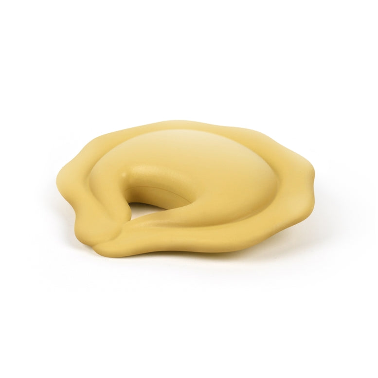 A pale yellow silicone pet lick mat or chew toy with a wavy, organic shape, shown on a clean white background.