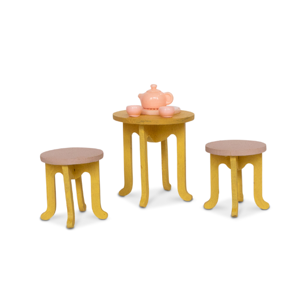 Set of toy furniture including a table and two stools on a white background