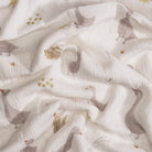 Fabric with a pattern of geese and plants on a white background