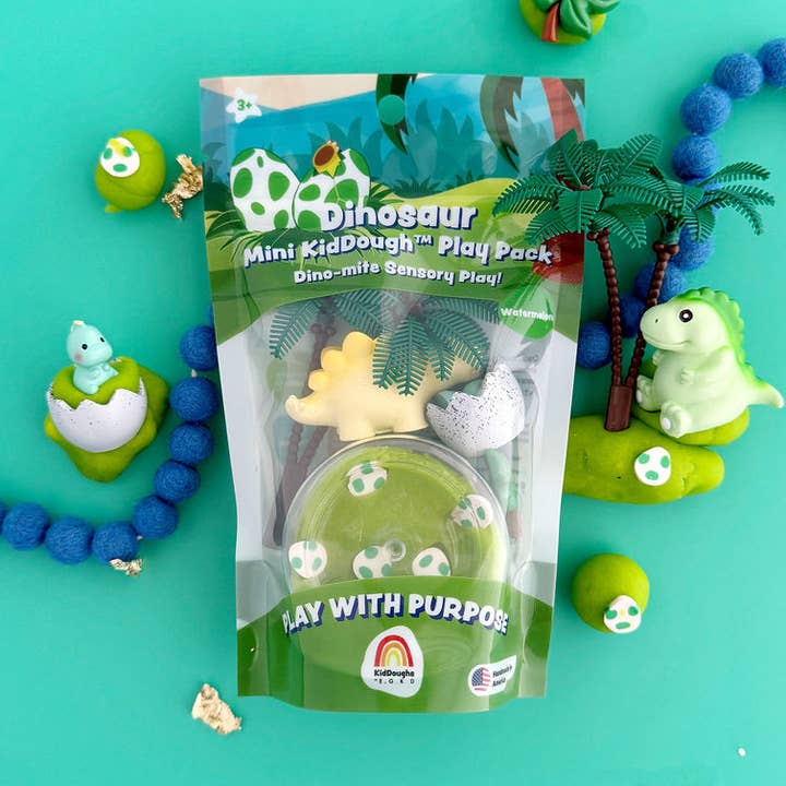 Dinosaur-themed mini kid dough play pack with toys on a teal background