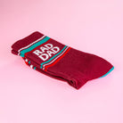 Maroon sock with 'RAD DAD' text on a pink background