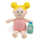 A soft plush doll with bright yellow hair styled in two buns, an embroidered face, a pink polka-dot outfit, and an accompanying miniature blue toy bottle standing next to it.