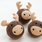 Three small felt reindeer toys with brown bodies, beige snouts and antlers, and black embroidered eyes, arranged on a plain white background.