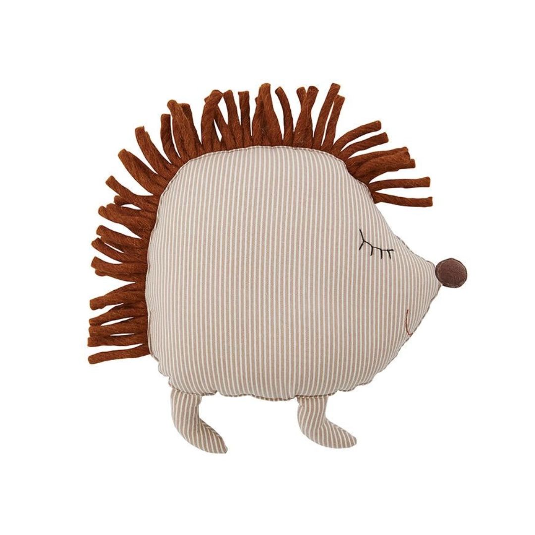 A plush hedgehog pillow with a beige and white vertically striped fabric body, brown faux fur spines, a small brown embroidered nose, and closed-eye detail, shown on a plain white background.