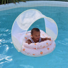 Baby in a inflatable pool seat with canopy in a swimming pool