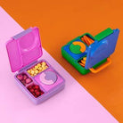 Colorful snack box with compartments on a two-tone pink and orange background