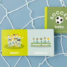 Two children's books titled 'Team' and 'Sideline' on a blue grid background with a soccer ball illustration.