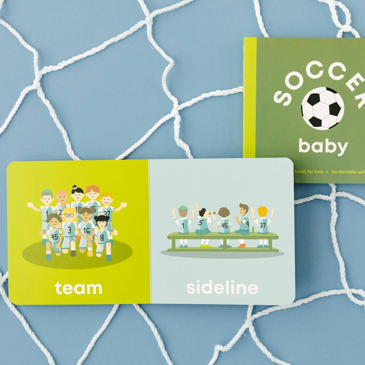 Two children's books titled 'Team' and 'Sideline' on a blue grid background with a soccer ball illustration.