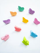 Colorful butterfly-shaped clips on a white background
