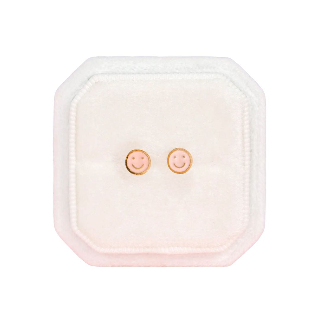Square pink case with smiley face earrings on a white background