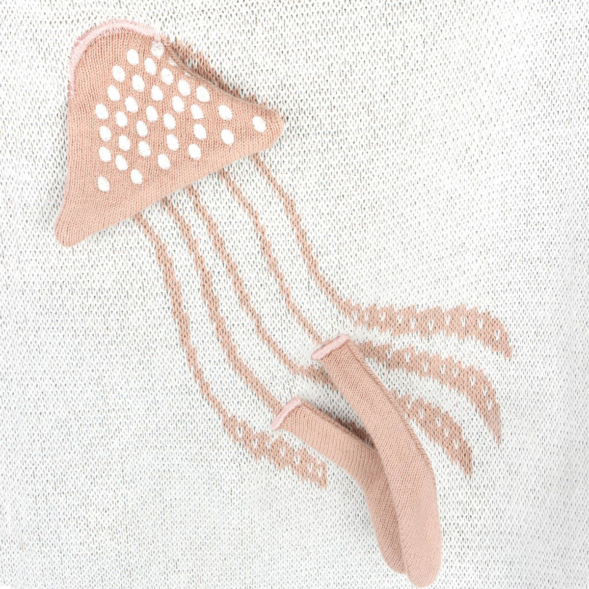 Pink jellyfish-shaped tool on a textured white background