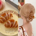 Decorative box with candy illustrations and a person wearing a hair clip.