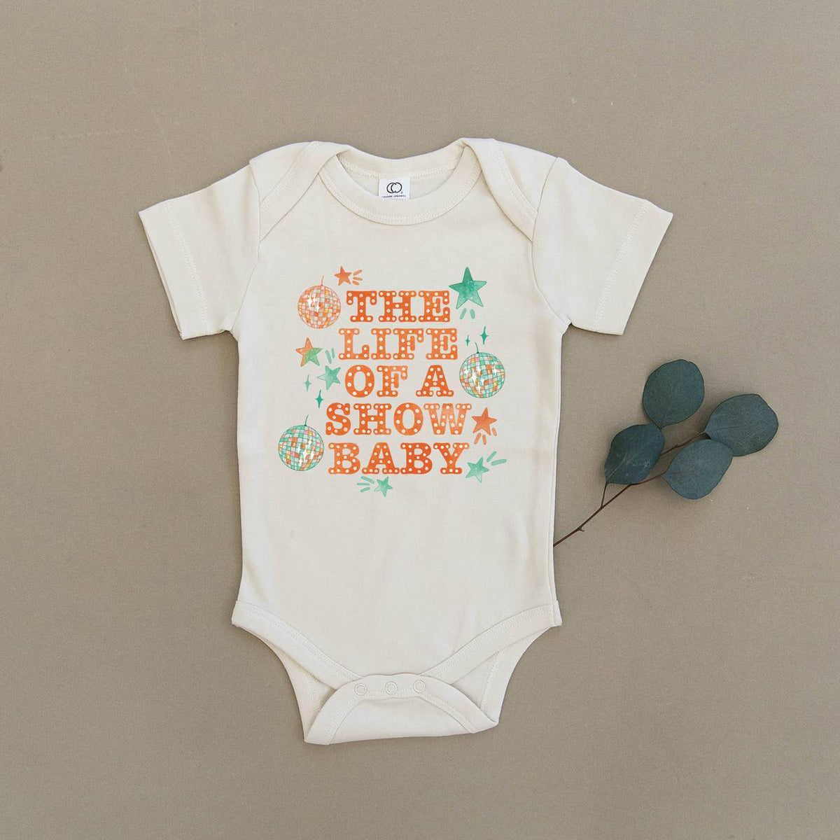 Baby onesie with text and graphics on a beige background