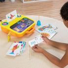 Child playing with educational toy on a wooden floor