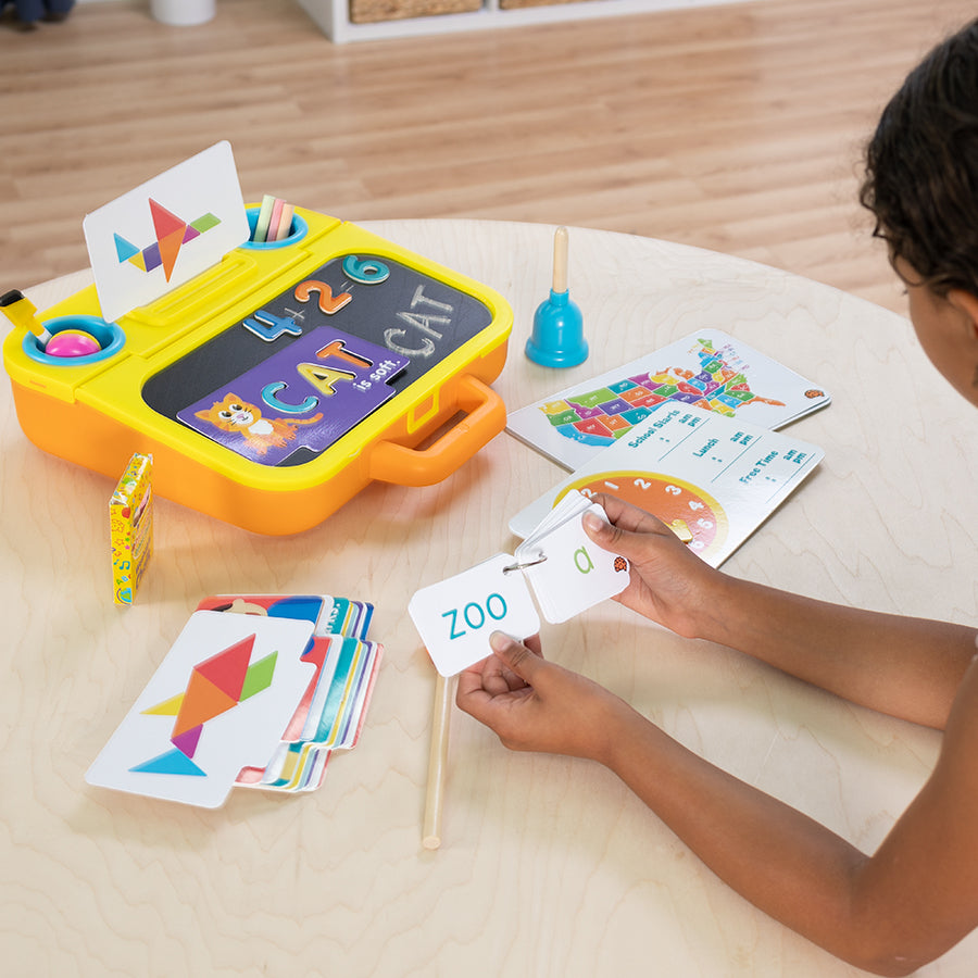 Child playing with educational toy on a wooden floor