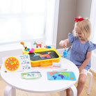 Child playing with educational toys at a table in a bright room