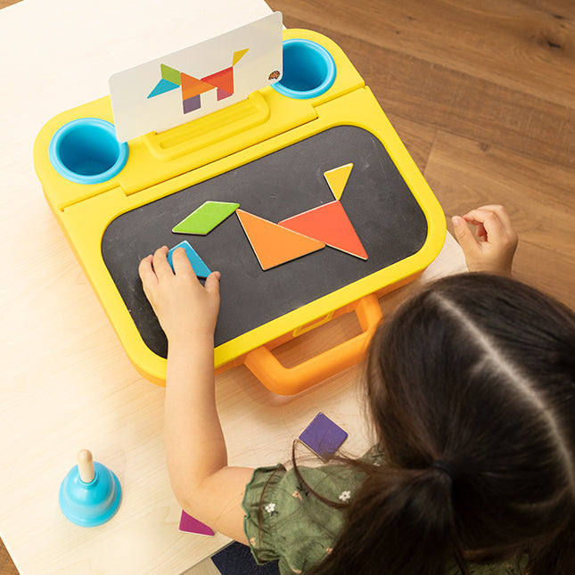 Child playing with a colorful educational toy on a wooden floor