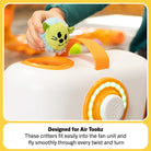 Toy fan with a small green creature attached, designed for Air Toobz, held by a hand.