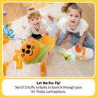 Two children playing with toy fur balls on a wooden floor.
