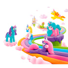 Colorful unicorn figurines on a rainbow path with a castle in the background