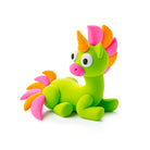 Colorful toy dragon with a unicorn horn on a white background