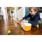 Child playing with a toy on a wooden floor