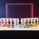 Collection of toy figures in packaging on a wooden surface with a dark background