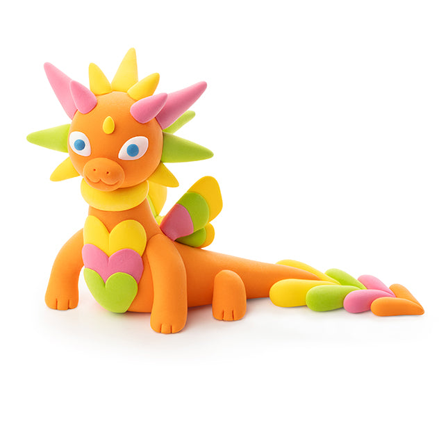 Orange dragon toy with yellow, geen and pink accents on a white background