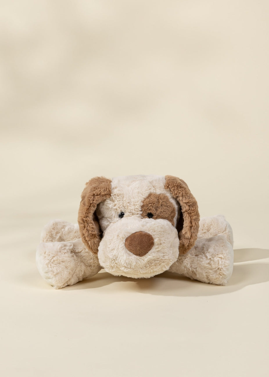 Plush dog toy with brown ears and nose on a beige background