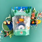Camping kiddough play kit with toys on a green background