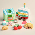 Set of colorful plush toys including a bakery, cake, and various food items on a beige background