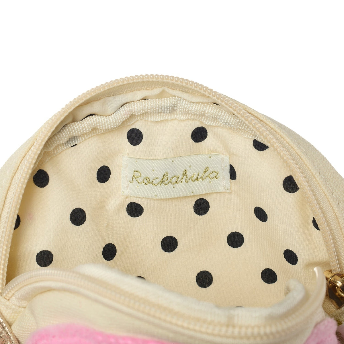 Close-up of a beige pouch with black polka dots and a Rockahula label.