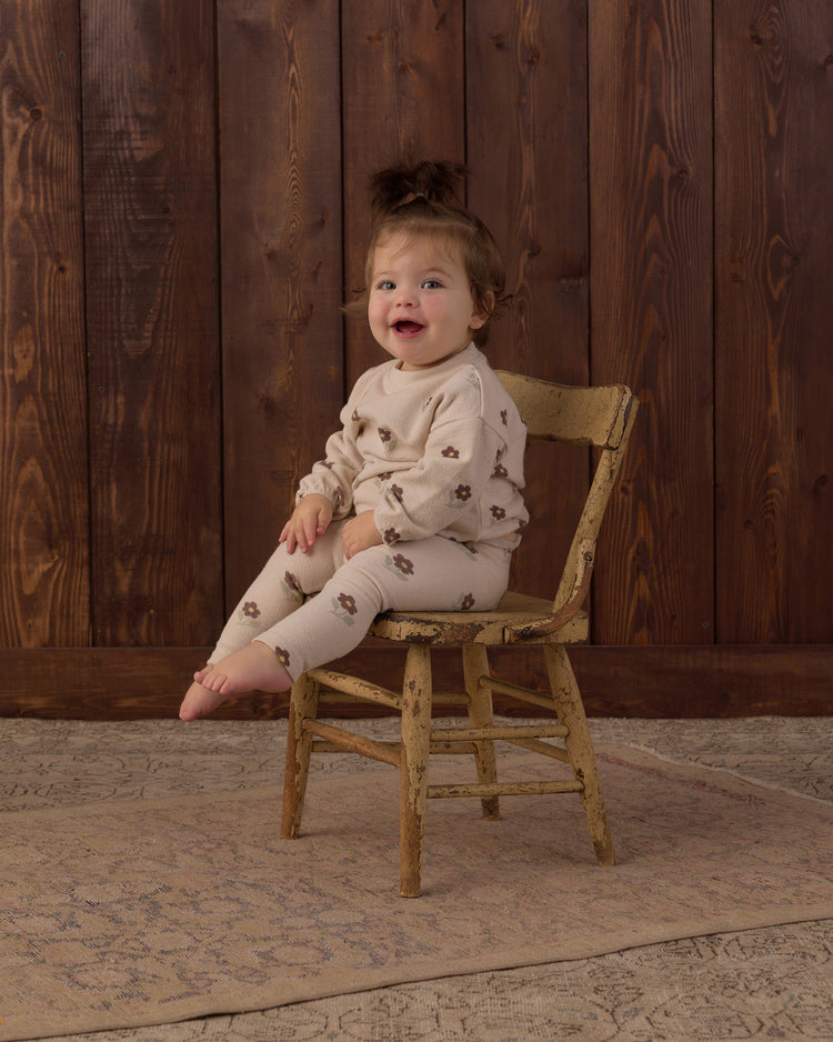 A toddler wearing the Rylee + Cru Spongey Knit Set in Petal Daisy featuring an all-over tiny floral print on soft beige knit fabric.