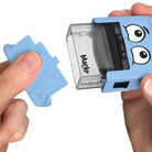 Blue Markr by OOLY stamp with cartoon face held by a hand on a white background