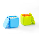 Two colorful silicone containers with food on a white background