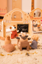 Toy setup with teddy bears in a classroom setting, including a blackboard.