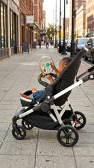 Child in a stroller on a city street