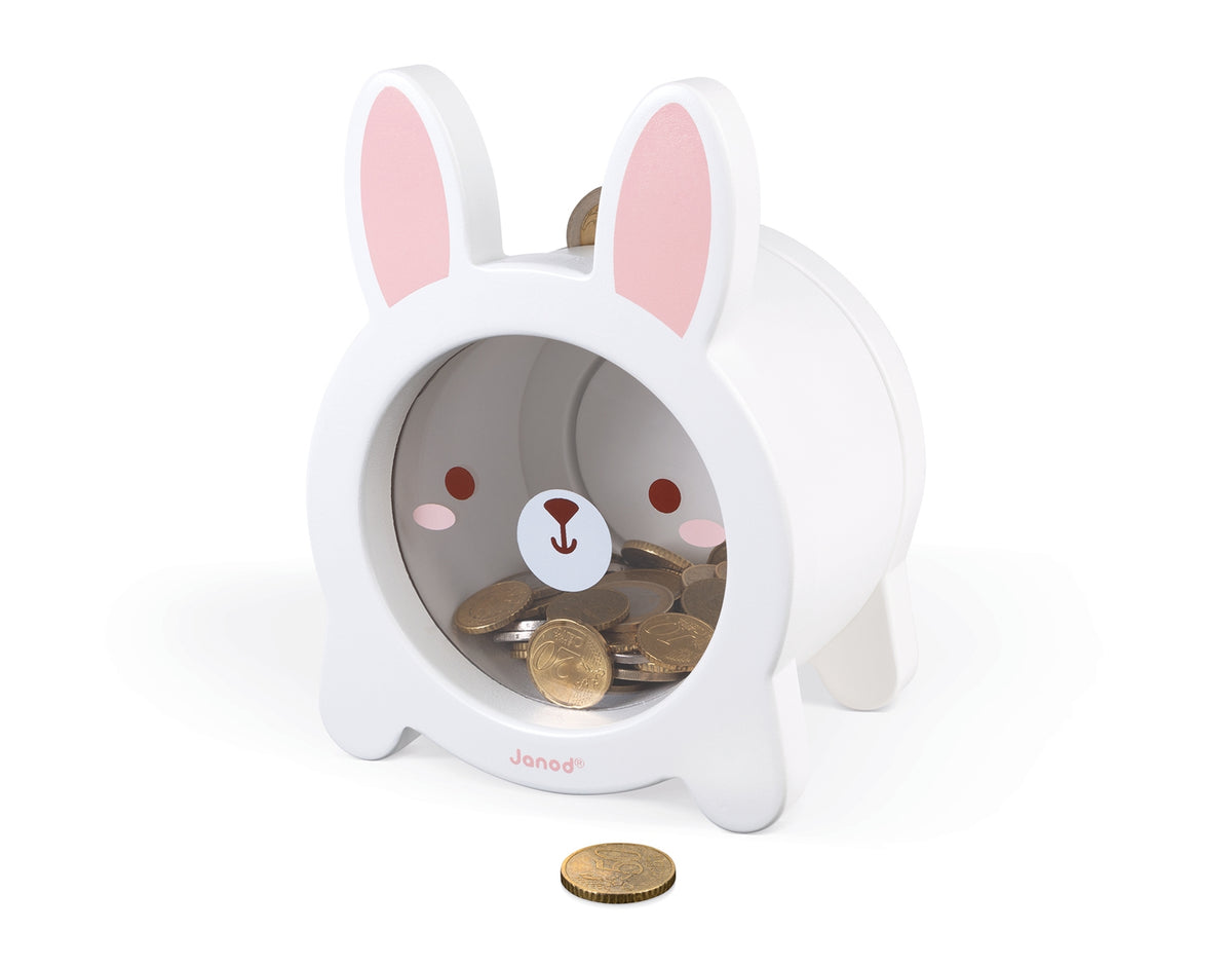 A white rabbit-shaped coin dispenser with pink inner ears and a cute bunny face on the front, shown on a clean white background with coins inside and one in front.