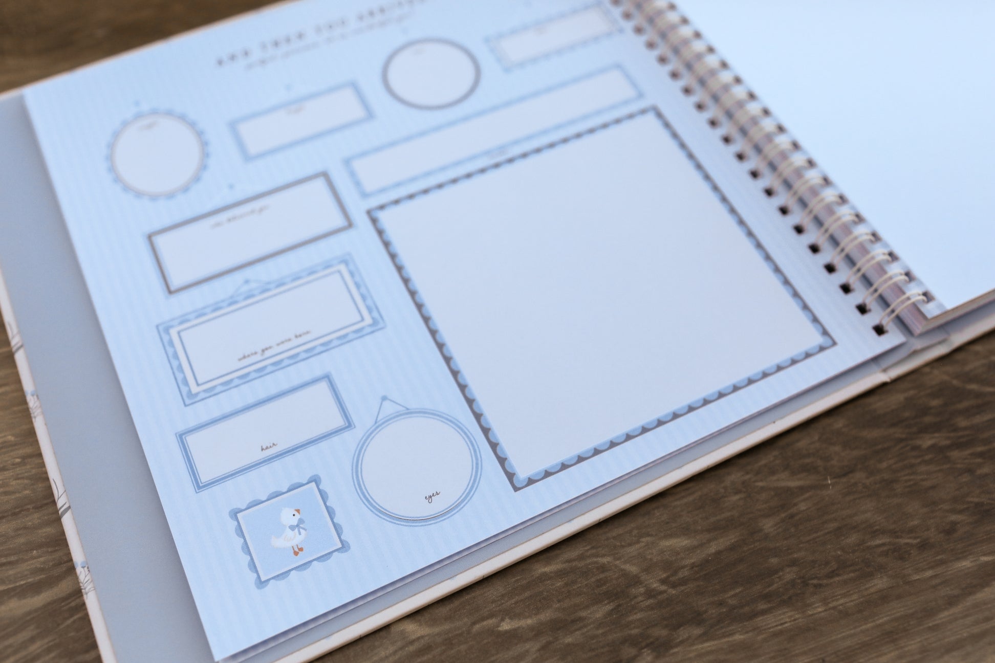Spiral-bound notebook with wireframe design on a wooden surface