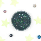 Black glittery container with stars and planets on a white background with star decorations