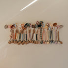 Row of colorful beaded bracelets on a white surface