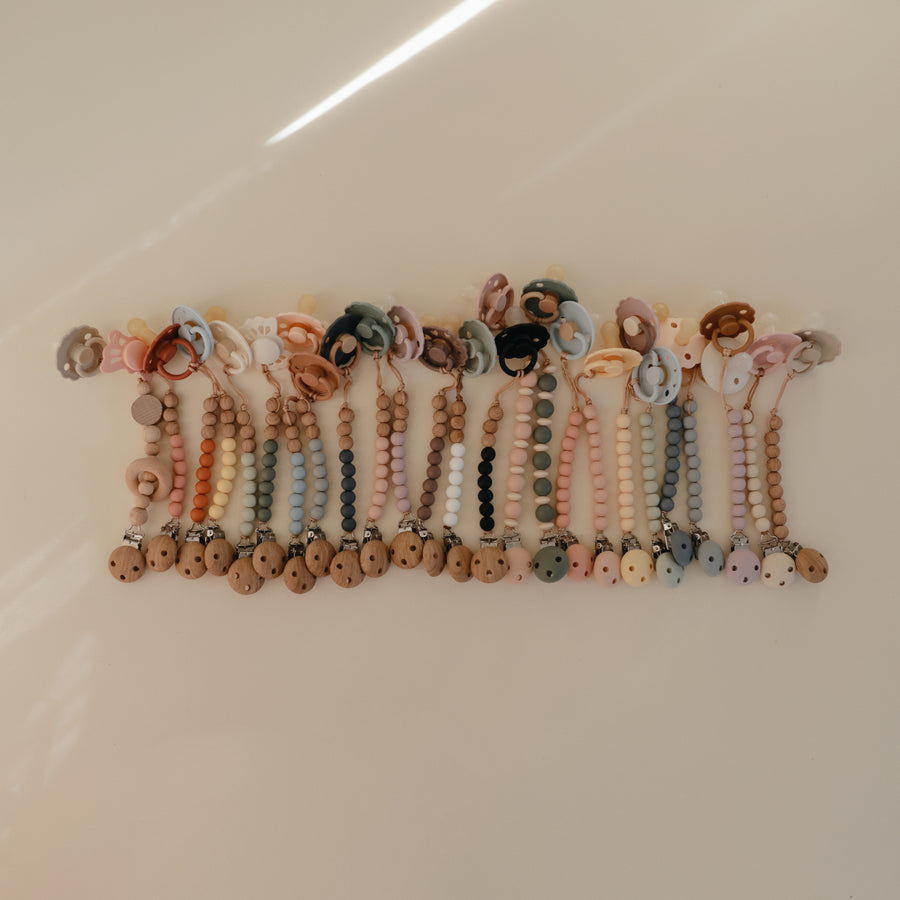 Row of colorful beaded bracelets on a white surface