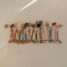 Row of colorful beaded bracelets on a white surface