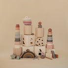 Stacks of colorful wooden toys on a beige background