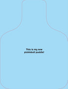 A light blue pickleball paddle graphic with a thin dark outline and centered text reading, 'This is my new pickleball paddle!' on a matching light blue background.