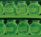 Green glass jars with plants on a green background.