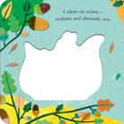 A children's book or craft page featuring a large white die-cut shape in the center, surrounded by an illustrated autumn border with acorns, leaves, and the text, 'I adore an acorn— walnuts and almonds, too.'.