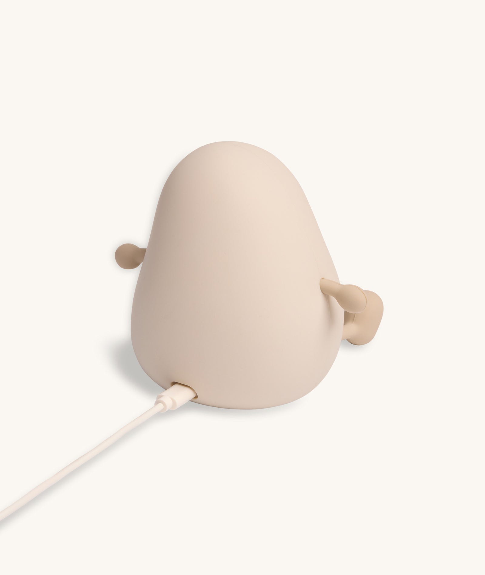 Beige lamp with a cable on a white background