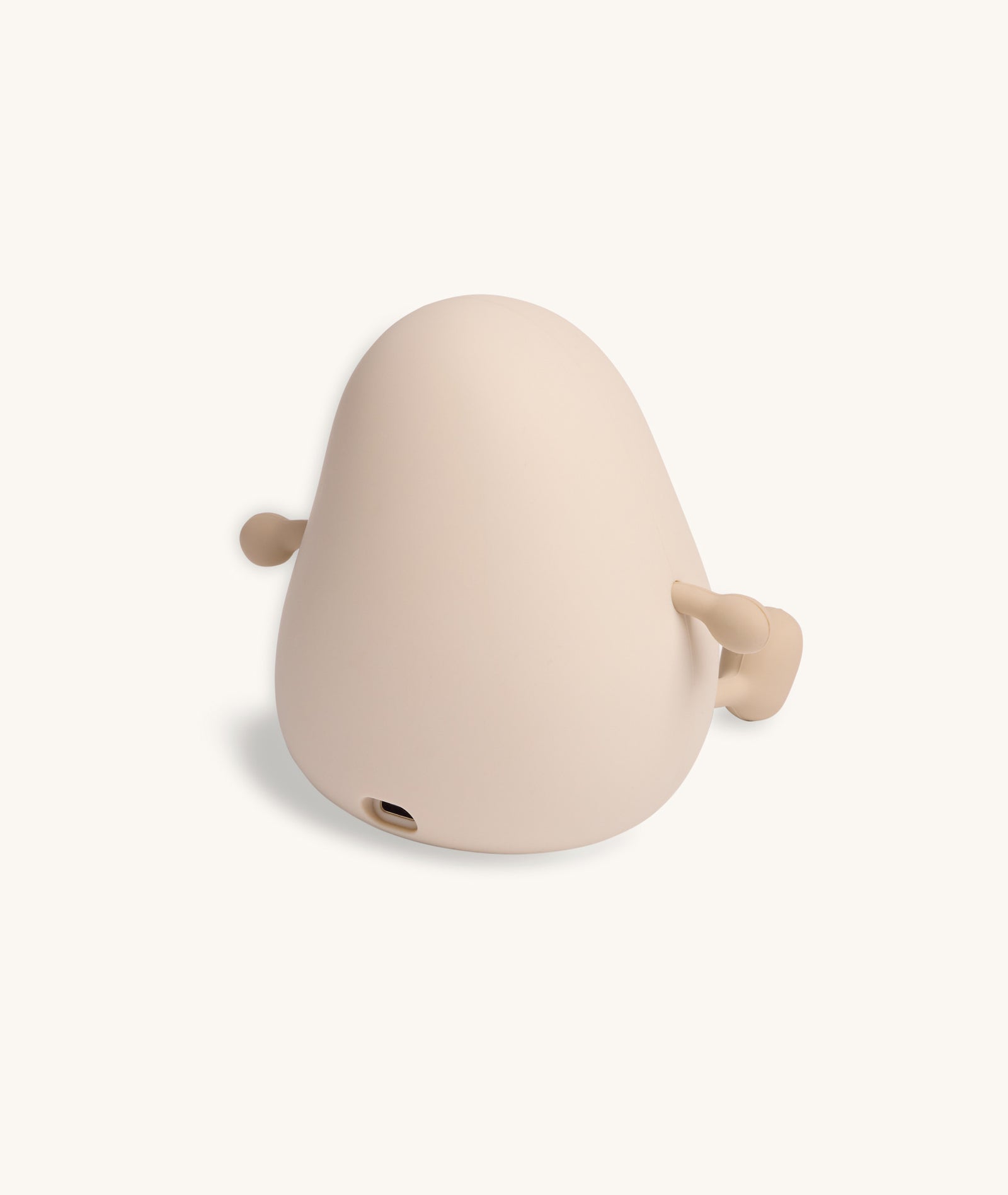 Beige whale-shaped object on a white background