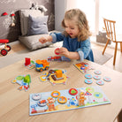 Child playing with educational toys on a wooden floor in a room with a couch and chair.
